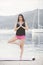 Fit healthy woman stretching on yoga mat on beach seaside,doing exercise abdominal crunches,training and lifestyle.