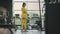 Fit hispanic woman performing weight lifting deadlift exercise with dumbbell at gym In yellow sportswear. woman brunette