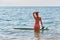 Fit lady enjoy ocean view. Surfboard float on sea water. Holiday, summer time, surfing, time to relax idea, copy space