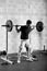 Fit male athlete completing a back squat