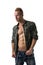 Fit male model wearing camouflage jacket on naked chest
