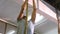 Fit man climbing rope in gym