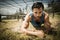 Fit man crawling under the net during obstacle course