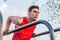 Fit man doing triceps dips on parallel bars at park exercising outdoors