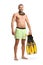 Fit man in swimwear with a diving mask standing and holding snorkeling fins