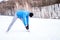 Fit man training and stretching outdoor in snow on a cold day