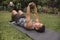 A fit middle aged asian man does some stretching while lying on the mat. Warming up before exercise outdoors