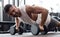 Fit and muscular man doing horizontal push-ups with dumbbells in gym