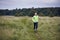 Fit muscular man jogging on a rural trail through grassland