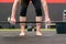 Fit muscular woman preparing to lift a barbell