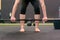 Fit muscular woman preparing to lift a barbell