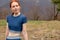 fit redhead woman resting in mountain viewpoint, in natural park outdoors, after sport