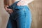 Fit slim female in blue jeans. Woman buttocks in denim.