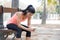 Fit sport woman looking at mobile phone internet app tracking performance after running workout sitting on park bench happy