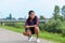 Fit sporty African woman crouching on a rural road