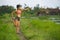 Fit and sporty runner Asian woman stretching leg and body after running workout on green field beautiful background in sport train