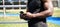 Fit sporty young black man using phone standing in workout park. Closeup