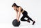 Fit and strong female athlete working out with a medicine ball to get better core strength and stability