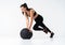 Fit and strong female athlete working out with a medicine ball to get better core strength and stability