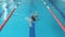 Fit swimmer girl jumping and cheering in swimming pool