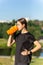 Fit tennage girl runner outdoors holding water bottle