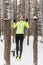 Fit woman athlete performing pull ups in a bar. Winter street outdoor training workout.