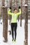 Fit woman athlete performing pull ups in a bar. Winter street outdoor training workout.