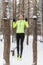 Fit woman athlete performing pull ups in a bar. Winter street outdoor training workout.