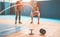 Fit woman with battle rope in functional training fitness gym - Tattooed personal trainer motivating female athlete inside