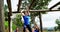 Fit woman climbing monkey bars while fit people cheering 4k