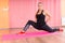 Fit Woman in a Deep Lunge Stretch on a Mat