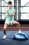 Fit woman doing exercise with bosu ball