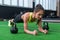 Fit woman doing plank exercise working on abdominal muscles in the gym