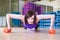 Fit Woman doing push-ups with Dumbbells on a floor in a Gym