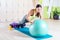 Fit woman doing push ups with medicine ball