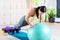 Fit woman doing push ups with medicine ball