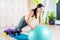 Fit woman doing push ups with medicine ball workout out arms Exercise training triceps and pectorals muscles