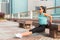 Fit woman doing triceps bench dips exercise while listening to music in headphones. Fitness girl working out in the city