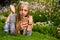 Fit woman with drinking water in a bottle checking her cell phone in a park or garden in London, England