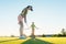 Fit woman exercising hitting technique during golf class with