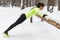 Fit woman exercising in woods doing push ups on a log at park. Outdoor training workout winter morning side view.