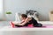 Fit woman high body flexibility stretching her leg