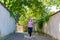 Fit woman jogging down a leafy shady lane