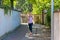 Fit woman jogging down a leafy shady lane