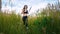 Fit Woman Jogging Exercising Running Cardio outdoor through the tall grass at summer field. Workout Female Runner.