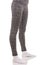 Fit woman legs wearing in grey sports thermal patterned pants in white socks