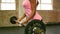 Fit woman lifting barbell weight