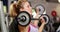 Fit woman lifting dumbbell