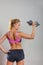 Fit woman lifting dumbbells weights