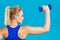 Fit woman lifting dumbbells weights